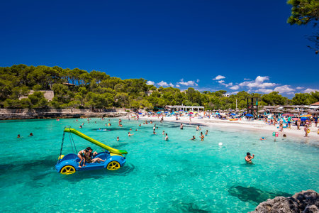 CALA MONDRAGO, Majorka, Spain, 24 July 2020 - People enjoy famous beach in summer, Parque Natural de...