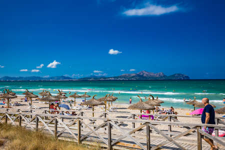 PLAYA DE MURO, Mallorca, Spain - 23 July 2020 - People enjoying hot summer day on popular sandy city beach in Mallorca.のeditorial素材