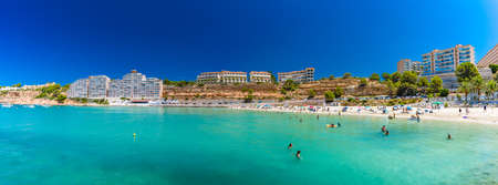 PORT ADRIANO, MALLORCA, SPAIN - 23 July 2020 - Tourists enjoying summer day on the popular city beach.のeditorial素材