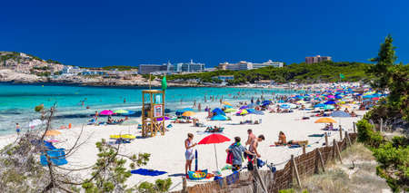 CALA AGULLA, MALLORCA, SPAIN - 21 July 2020: People enjoying summer on the popular sand beach on Mallorca,  Balearic Islands.のeditorial素材