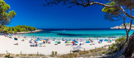 CALA AGULLA, MALLORCA, SPAIN - 21 July 2020: People enjoying summer on the popular sand beach on Mallorca,  Balearic Islands.のeditorial素材