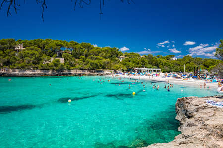 CALA MONDRAGO, Majorka, Spain, 24 July 2020 - People enjoy famous beach in summer, Parque Natural de Mondrago. Santanyi. Malorca. Spainのeditorial素材