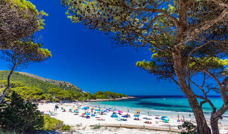 CALA AGULLA, MALLORCA, SPAIN - 21 July 2020: People enjoying summer on the popular sand beach on Mallorca,  Balearic Islands.のeditorial素材