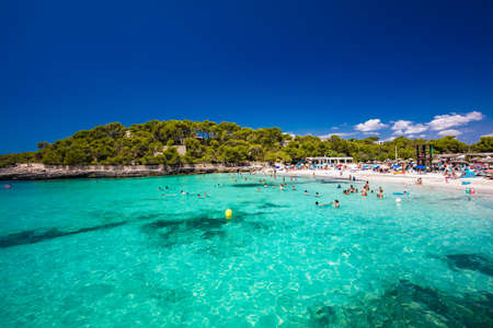 CALA MONDRAGO, Majorka, Spain, 24 July 2020 - People enjoy famous beach in summer, Parque Natural de Mondrago. Santanyi. Malorca. Spainのeditorial素材