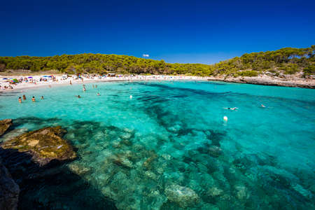 CALA MONDRAGO, Majorka, Spain, 24 July 2020 - People enjoy famous beach in summer, Parque Natural de Mondrago. Santanyi. Malorca. Spainのeditorial素材