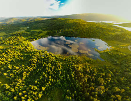 Bamselitjernet lake near Beitostolen surrounded by forests during the sunset, Norwayの写真素材