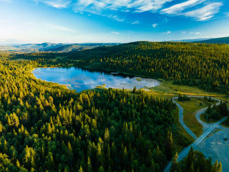 Bamselitjernet lake near Beitostolen surrounded by forests during the sunset, Norwayの写真素材