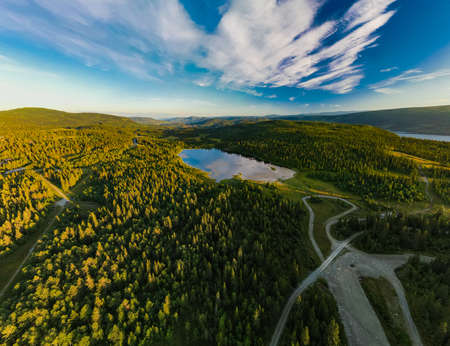 Bamselitjernet lake near Beitostolen surrounded by forests during the sunset, Norwayの写真素材