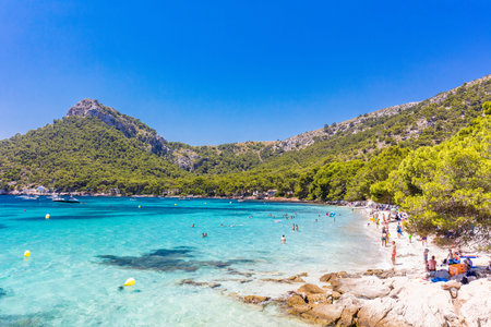 Platja de Formentor, Mallorca, Spain - July 20, 2020: People enjoying the popular beach in summer, Mallorca, Spain.のeditorial素材