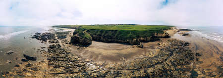 Sunny Cliffs and beach at Blackhall Rocks and Cromdon Dene Beachの写真素材
