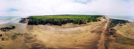 Sunny Cliffs and beach at Blackhall Rocks and Cromdon Dene Beachの写真素材
