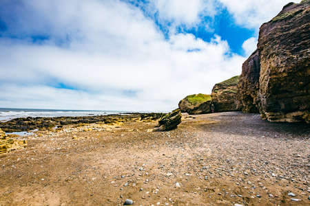 Sunny Cliffs and beach at Blackhall Rocks and Cromdon Dene Beachの写真素材