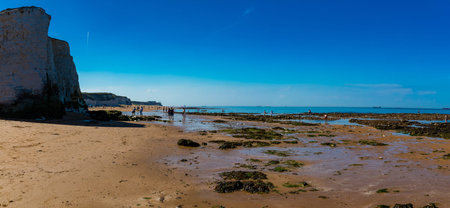 MARGATE, Kent, UK: 21 May 2020: Visitors to Margate's Main Sands beach surrounded by white cliffs...