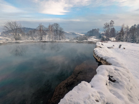 Travertine lake with hot water close to the spa Vysne Ruzbachy, Slovakia, during winterの写真素材