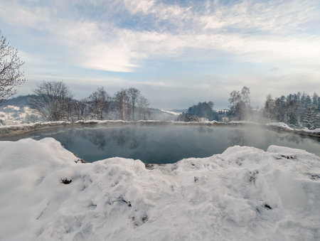 Travertine lake with hot water close to the spa Vysne Ruzbachy, Slovakia, during winterの写真素材