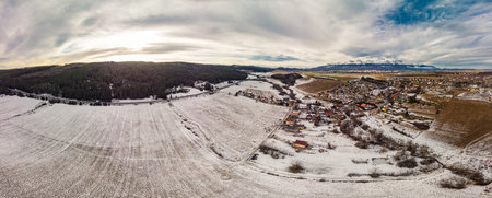 Drone view of Ganovce village with the view of High Tatras, Slovakiaの写真素材