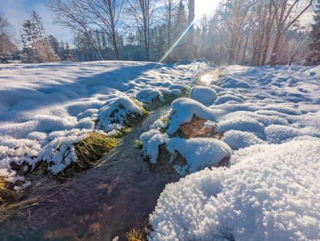 Travertine lake with hot water close to the spa Vysne Ruzbachy, Slovakia, during winterの写真素材