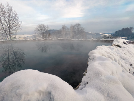 Travertine lake with hot water close to the spa Vysne Ruzbachy, Slovakia, during winterの写真素材