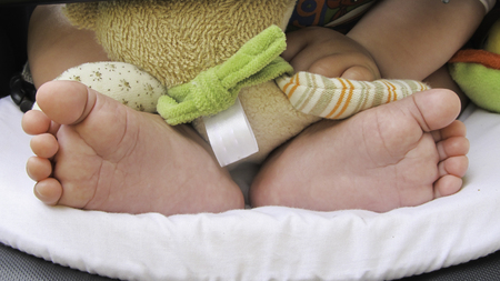 Foot of newborn on the strollerの写真素材