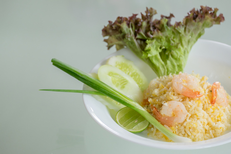 Thai fried rice with prawns in white plateの写真素材