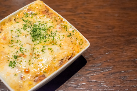 Lasagna in plate on wooden tableの写真素材