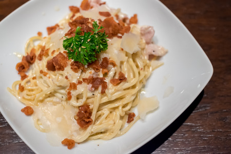 Spaghetti Carbonara in plate on wooden tableの写真素材