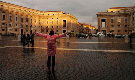 Woman in raincoat in sunset at the vaticanのeditorial素材