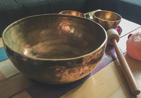 Singing bowls on a table for relaxation and healthの写真素材