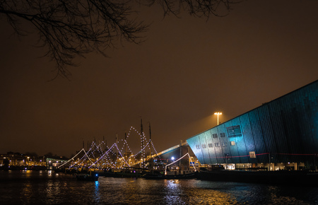 Boat shaped building in Amsterdam harbor in the Netherlandsの写真素材