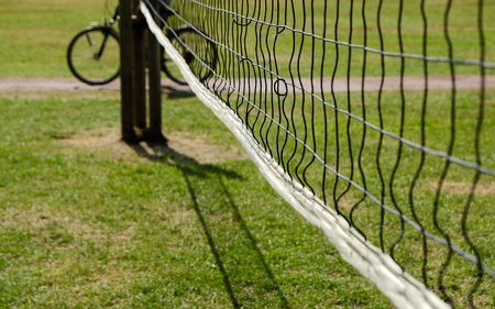 Volleyball net with bicycle on a sunny dayの写真素材