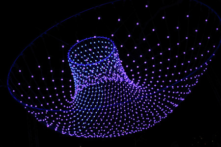 Colorful lights in a circle shaped net at the amsterdam light festivalの写真素材