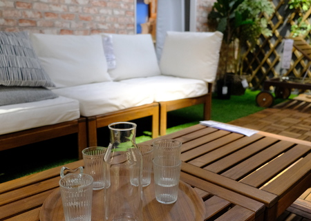 glasses on a table and a bench on a balconyの写真素材