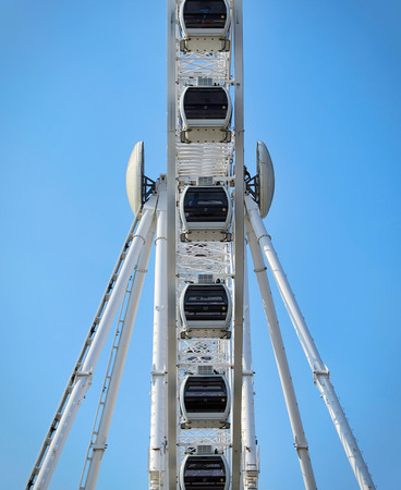 Ferris wheel on a blue sky background in the summer. Low angle vertical shootの写真素材