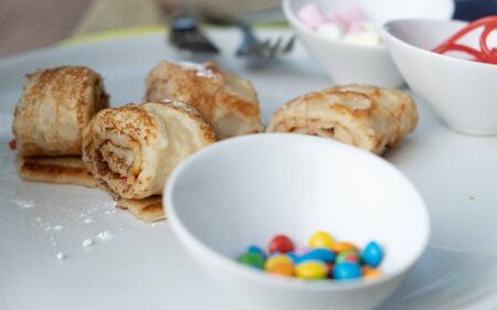 Fast food candy bar desserts during food festival. Crepes and langosi meaning gogosi , filled with different ingredients like chocolate, candy and sugary foods, traditional unhealthy many calories. amsterdam netherlandsの写真素材