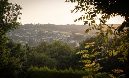 Evening sunset with trees silhouette over English countryside landscape from a hill peak in charmouth great brittainの写真素材