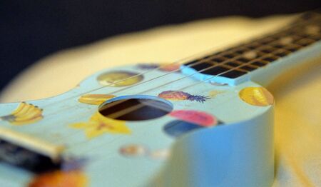 Closeup of a ukulele blue on white cushion in amsterdamの写真素材