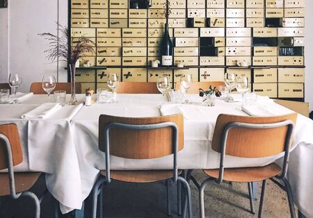 restaurant in bank vault with lockers and wine and chairs and tablesの写真素材