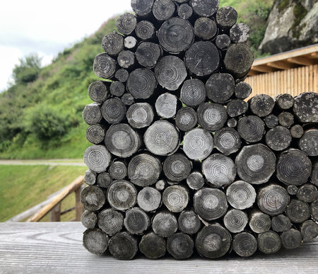 pile of wood chopped in mountains on a bench