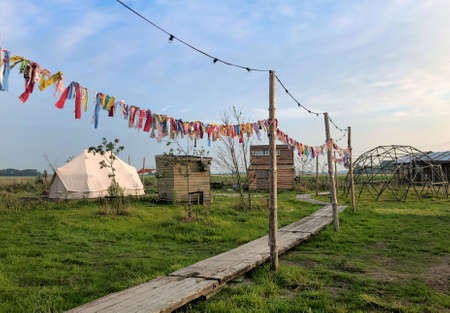 various huts placed around a festive meadowの写真素材