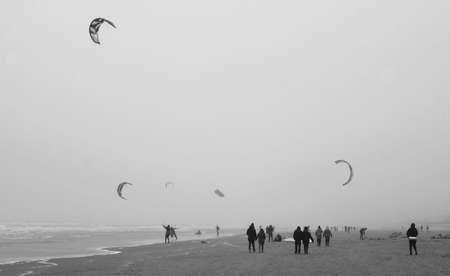 kitesurfers at sea suring a storm at a dutch beach in amsterdamの写真素材