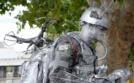silver painted street artist dressed as a robotの写真素材