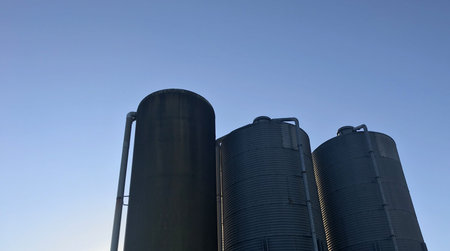 grain silos against a blue sky in amsterdam