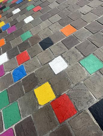 colored tiles on a pavement in a downfacing perspective in reims