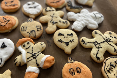 orange and white scary halloween cookies on a baking plate in amsterdamの写真素材
