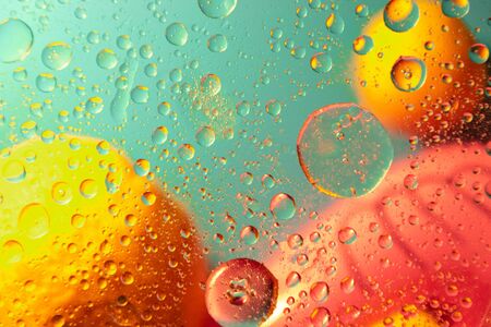 Abstract pattern of colored oil bubbles on water. Oil drops in water abstract psychedelic pattern image.の写真素材