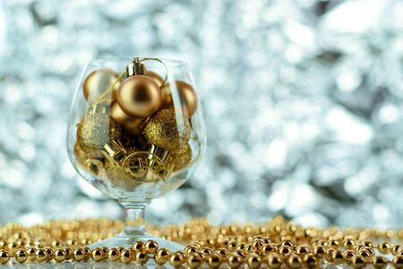Christmas balls, wine glass, christmas decorations on silver abstract background. Christmas composition.の写真素材