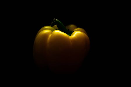 Fresh yellow capsicum paprika isolated on black. Healthy eating concept. Bell pepper isolated on black.の写真素材