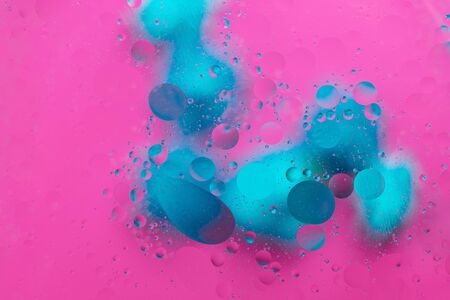 Abstract pattern of colored oil bubbles on water. Oil drops in water abstract psychedelic pattern image.の写真素材