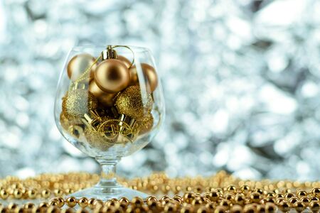 Christmas balls, wine glass, christmas decorations on silver abstract background. Christmas composition.の写真素材