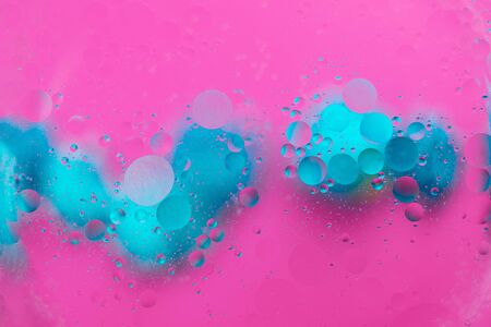 Abstract pattern of colored oil bubbles on water. Oil drops in water abstract psychedelic pattern image.の写真素材